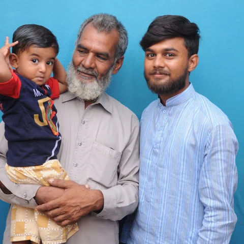 A grandfather with his son and young grandson