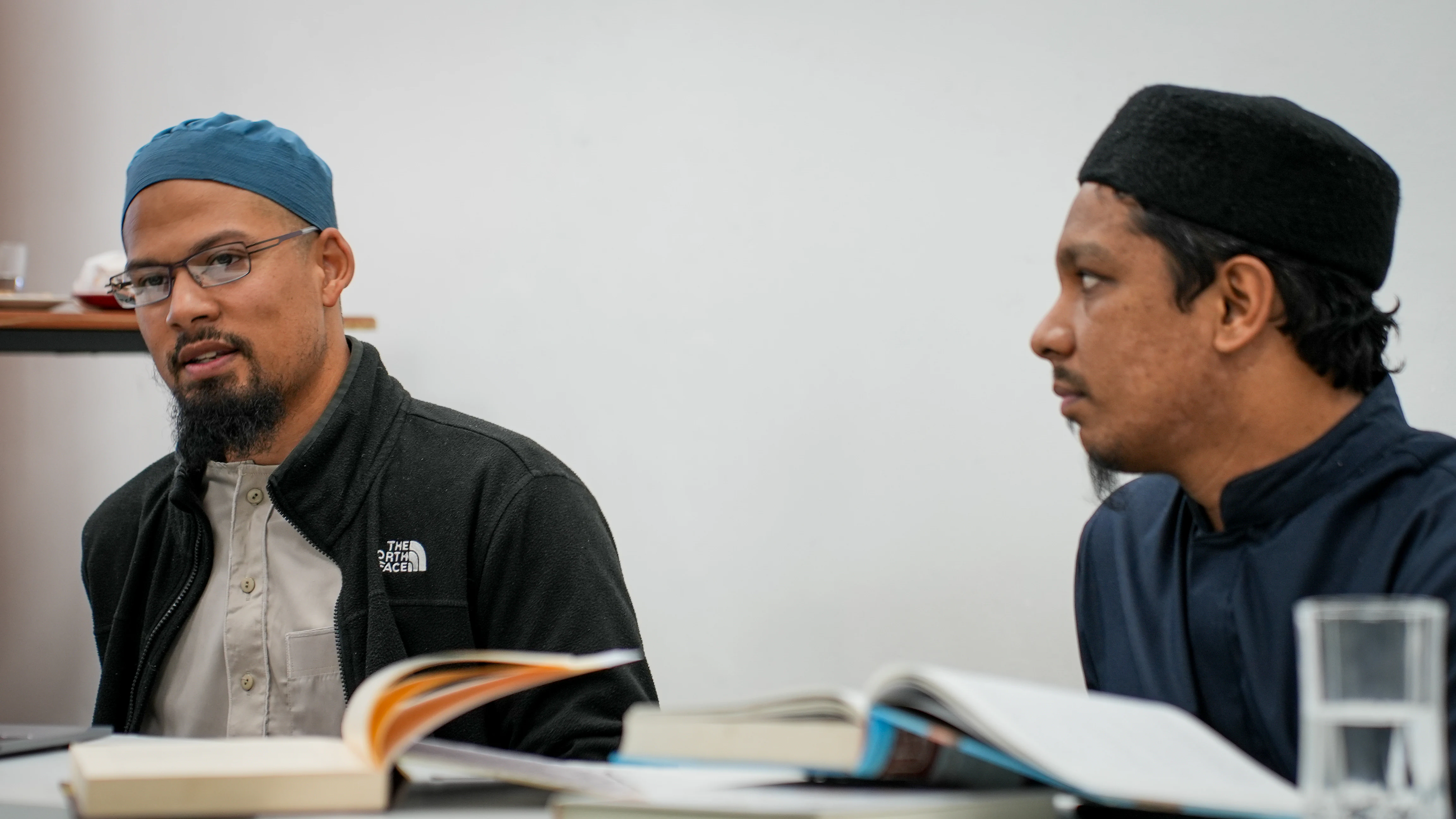 Department scholars consulting legal texts during the Majlis al-Iftāʾ